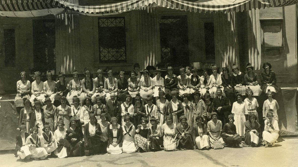 San Diego Normal School students pose under an awning on the steps of the campus Main Building, 1921.