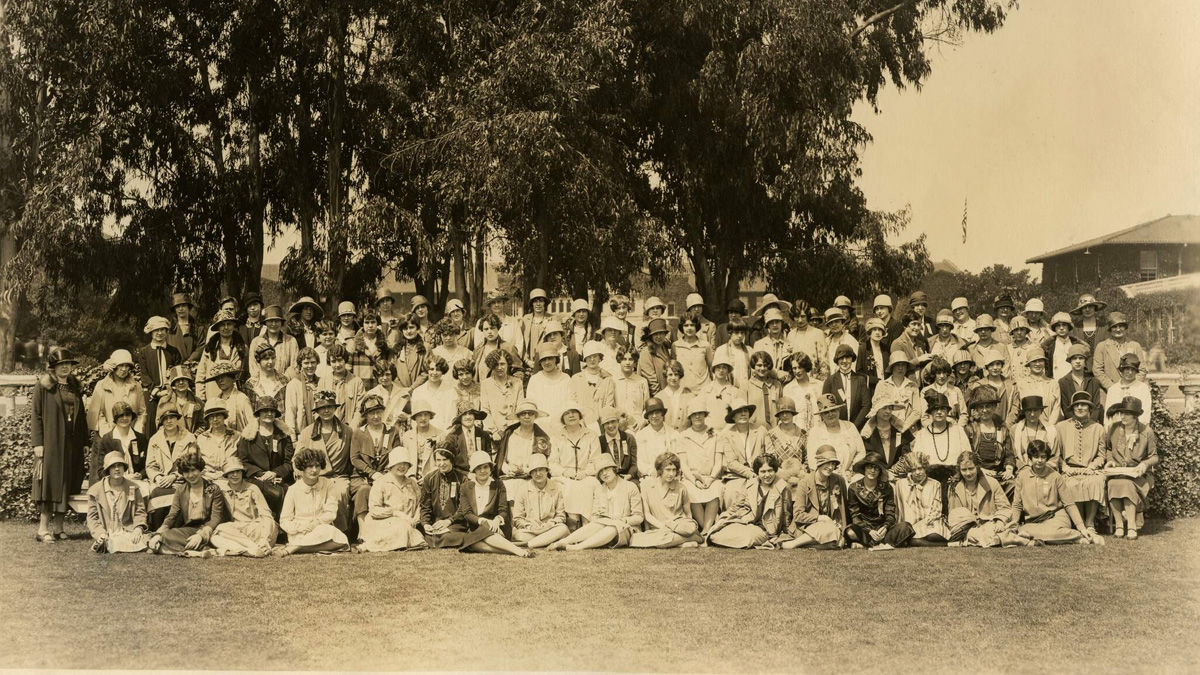 Orchestra and choral group perform in front of students and faculty assembled on the steps of the San Diego Teachers College campus in University Heights.