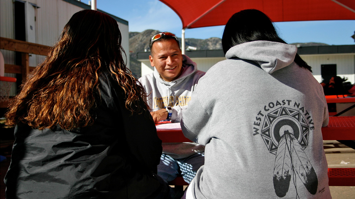 Master's student Darrick Franklin working with students from All Tribes School, early 2000s. Franklin now advises the Navajo Nation president on education issues.