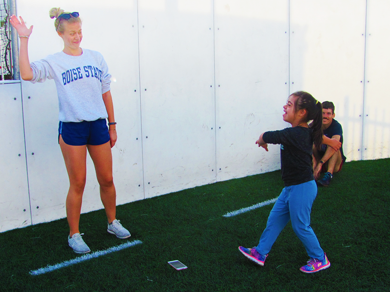 Two girls about to high five.