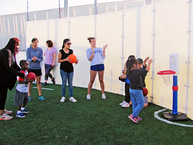 People playing with Playskool basketball pole