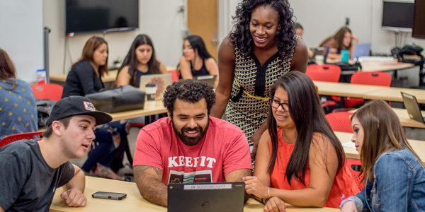 People around a laptop