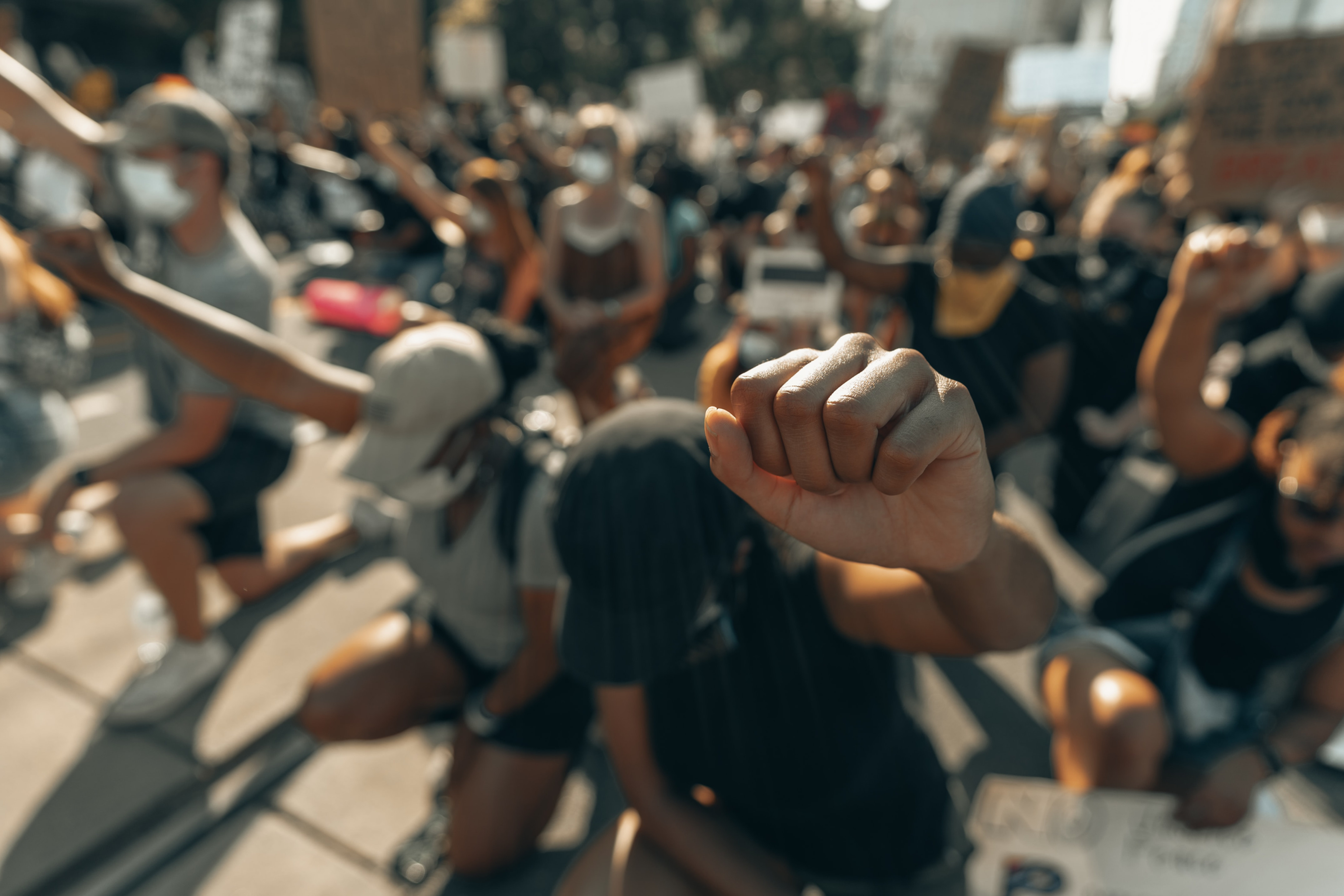 black students with fist up in solidarity