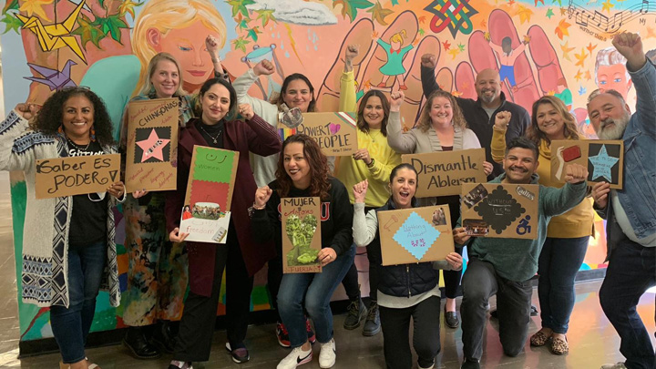 CCLEAD students with signs about empowerment