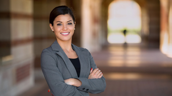 latina woman standing in university hallway