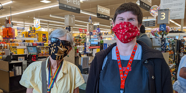 Susan (left), a CSA support facilitator, meets up with Kathy, an essential employee, at the end of a work shift.