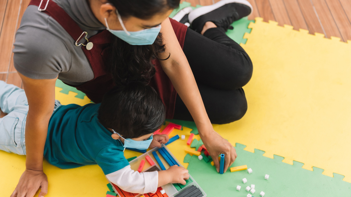 Woman playing with boy.