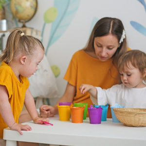 Woman and two girls playing.