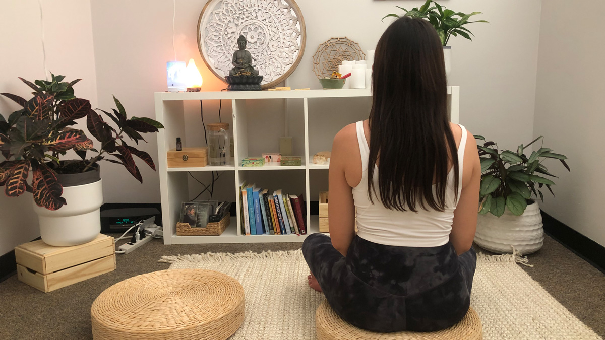 A student meditates in the Self-Care Sanctuario