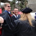 Graduate students from the Class of 2025 and faculty celebrate outside Viejas Arena.