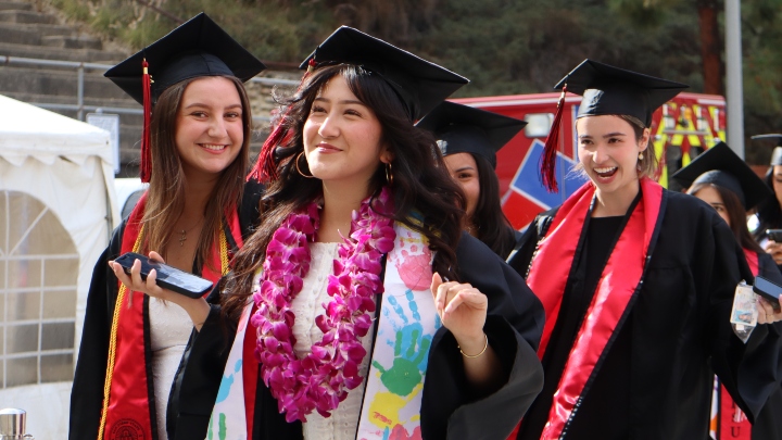 Undergraduate students from the Class of 2025 celebrate outside Viejas Arena. Photo by Sarah Wilkins.