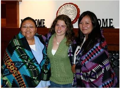 3 NAISC scholars pose, 2 of them are wearing Honoring Blankets